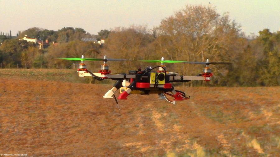Spray drone flying low over a crop field